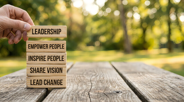 Wooden blocks stacked with leadership principles for team building