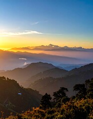 Obraz premium A serene mountain landscape at sunrise with clouds and mist