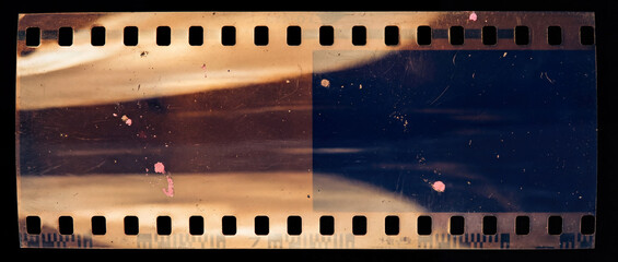 beginning of a 35mm film strip isolated on a black background, showing vintage analog texture,...