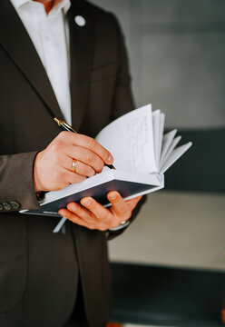 Businessman writes notes in meeting during afternoon at office space with modern design