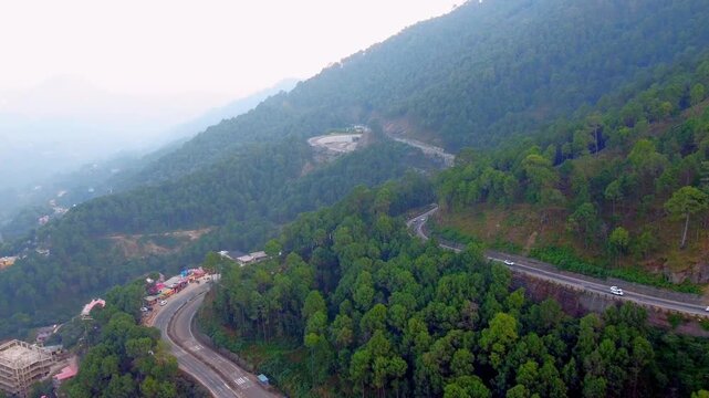 Scenic Winding Road Amid Lush Green Deodar Trees and Pine Forests in Solan Hills, Drone Shot of Curvy Hill Road Surrounded by Dense Cedar and Pine Forest in Solan