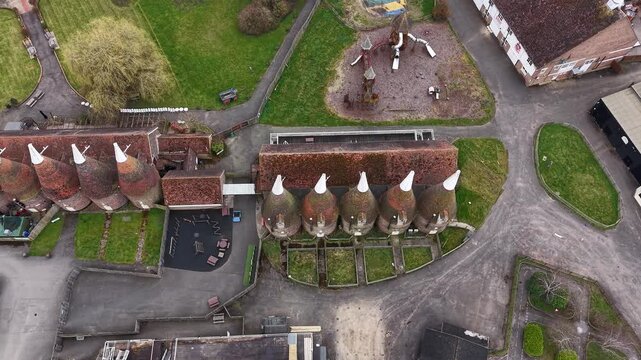 Kent Hop farm aerial Birdseye view over rows of kilning oast houses country park in Tonbridge