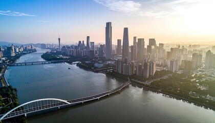Fototapeta premium An aerial view captures a sprawling cityscape bathed in the warm glow of sunrise, showcasing modern architecture, winding rivers, and connecting bridges.