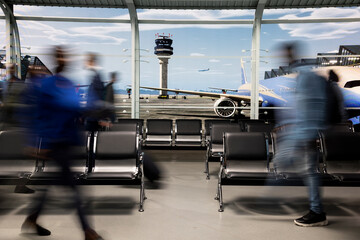 Walking rapidly, blurred motion and crowd in busy airport lounge. Navigating chaotic environment, long flight layover and group of passengers in transit hub before departure