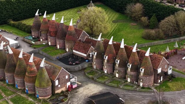 Hop farm aerial view overlooking rows of oast houses in Kent agricultural country park in Tonbridge