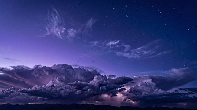 Moody night thunderclouds under violet starry sky