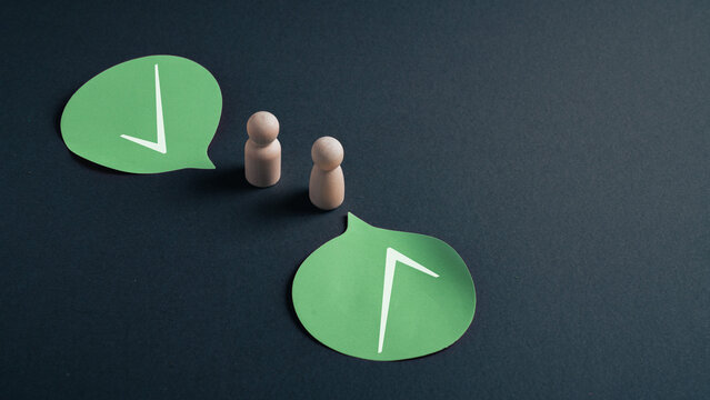 Strategic alignment and shared direction concept with wooden figures and arrow icons in speech bubbles