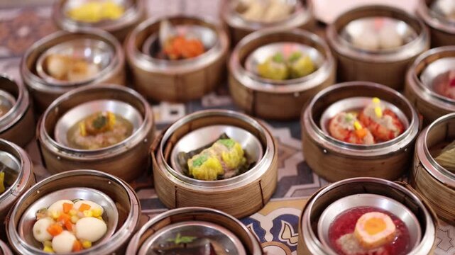 Dim sum restaurant with traditional chinese food. assortment of steamed dumplings served in bamboo baskets on table with motion.