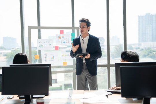 Caucasian business man giving flipchart presentation in the office