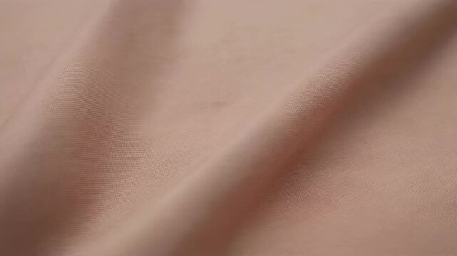 Soft pink fabric with gentle folds and fine texture, close-up textile surface