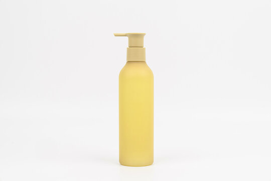 Matte yellow cosmetic pump bottle mockup on white background