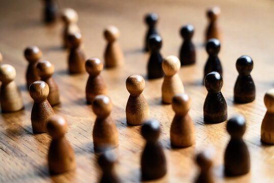 Wooden game pieces (pawns) arranged on a wooden surface, resembling a game of Settlers of Catan.