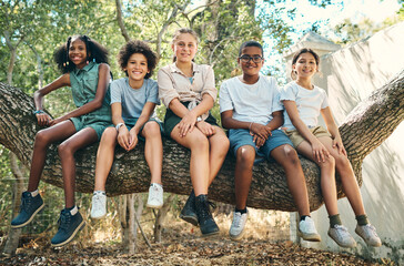 Friends, portrait or children on tree trunk with smile, positive growth or bonding on summer break. Happy, group of kids with connection, peer adventure and social development in outdoor holiday. © peopleimages.com