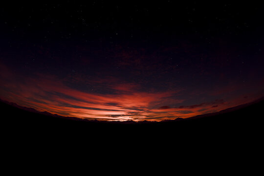 3D twilight horizon landscape with dark ridge and ember sky