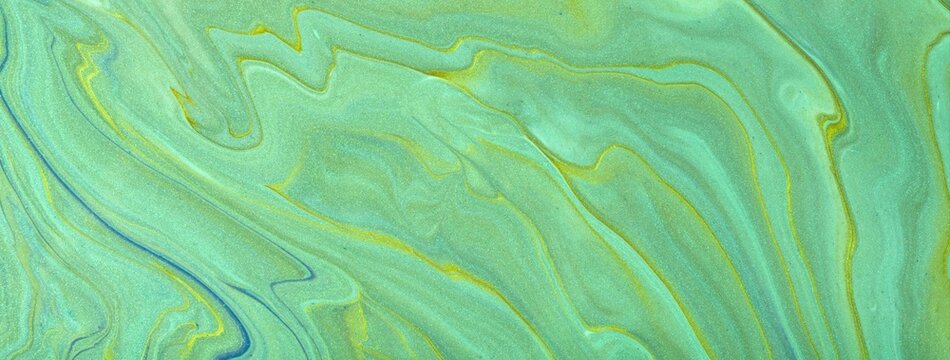 Abstract fluid art background in light mint green tones with marble texture and acrylic pour painting style, macro
