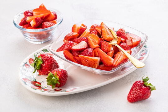 Fresh ripe delicious organic strawberries on a plate on kitchen table