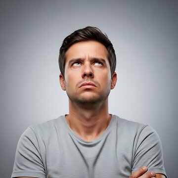 Man with a skeptical expression looking upwards in contemplation.
