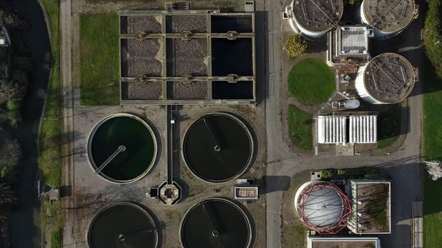 Aerial view of the water treatment plant showcasing the contrast of circular and rectangular tanks, Lisbon, Portugal.