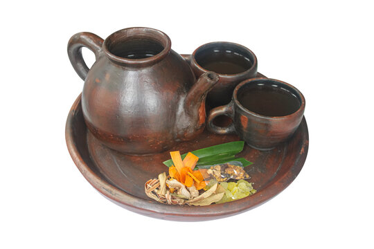 Traditional Indonesian Wedang Uwuh Herbal Tea with Clay Teapot and Cups