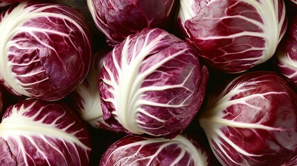 Obraz premium Crisp and Vibrant Crimson Radicchio Rosettes Displayed in a Fresh Produce Market Setting