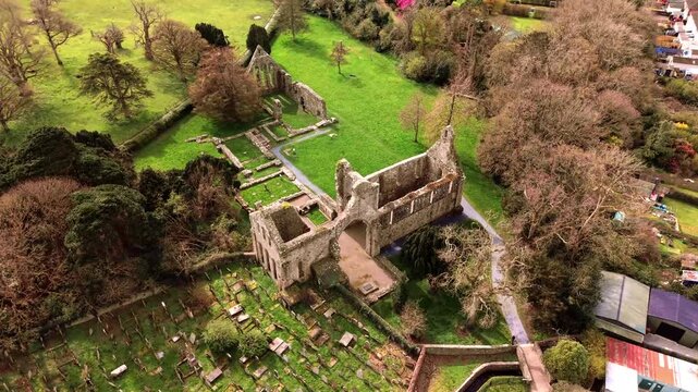 Descending 4K 60FPS aerial video GV of Greyabbey Monastery Ruins in Greyabbey, County Down in Northern Ireland. Produced in 3840x2160 and with Rec709 color.