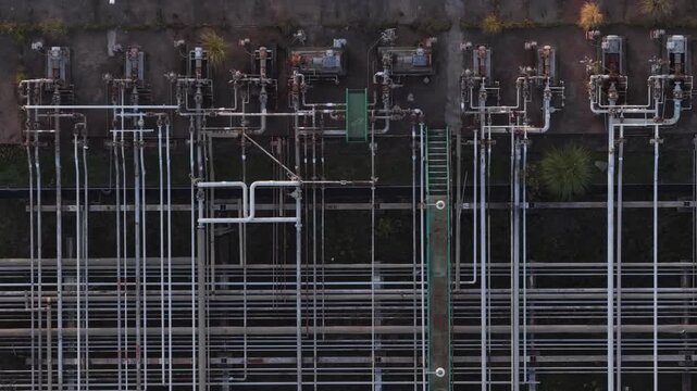 Aerial view of an industrial pipeline structure with a complex web of pipes and machinery, creating a stark industrial scene, Sines, Portugal.