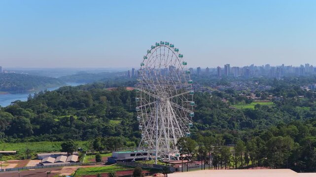 Aerial drone footage of the Yup Star Ferris wheel with Foz do Iguacu skyline in the background.