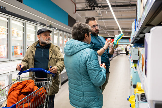 Family members discussing products and choosing items during a grocery trip at the store