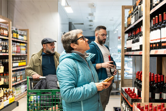 People shopping for alcoholic beverages in a grocery store
