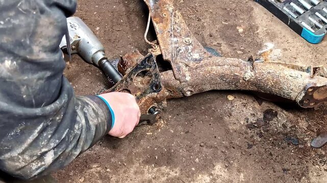 Automotive Repair Work. Removal Of Rusted Rear Axle or Subframe On A Vehicle. Close-up Shot