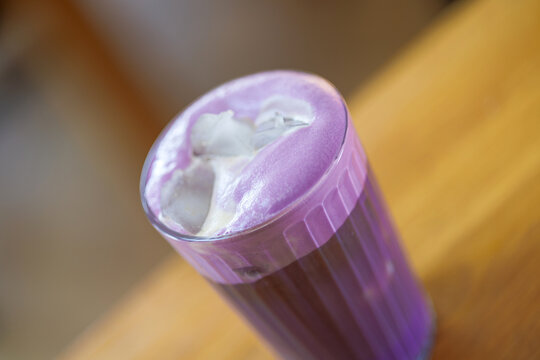 A refreshing ube iced coffee served in a clear glass