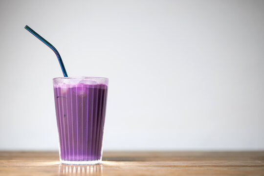 A refreshing ube iced coffee served in a clear glass
