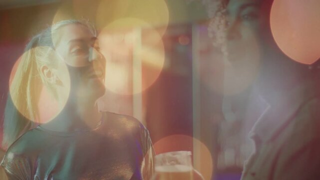 Metal-top woman starting speech holding drink, shot zooming out, bokeh on drinks, toasting at event