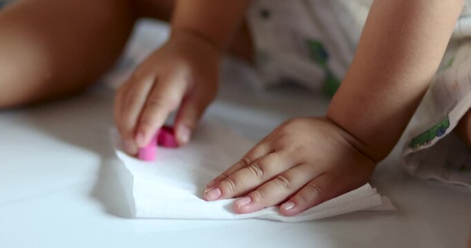 Toddler playing with wooden blocks while cleaning toys, representing early childhood learning, hygiene habits, responsibility, development skills, and positive parenting at home, close-up