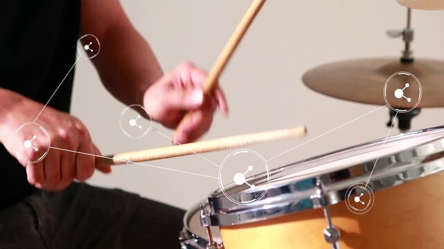 Drummer starting on poised sticks, playing fast strokes while white nodes tracking motion for music