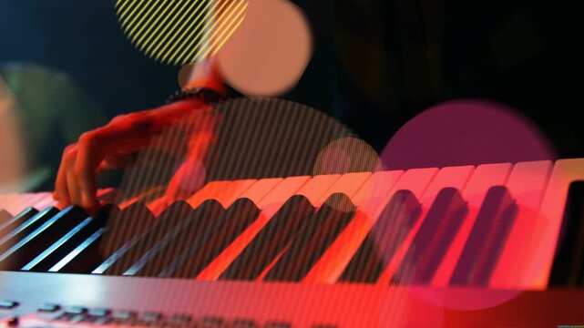 Forearm entering frame, keyboardist pressing keys and alternating chords for music, bokeh rising