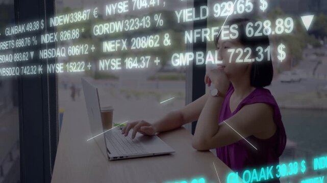 Woman typing on laptop by window, market ticker sweeping, pausing her typing, tracking finance