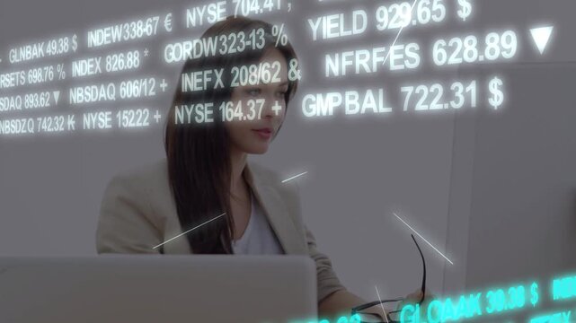 Vertical video: Analyst reaching laptop, causing market tickers flowing over face while watching FX