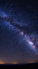 Obraz premium Milky Way Galaxy Shines Brightly Over Dark Landscape.