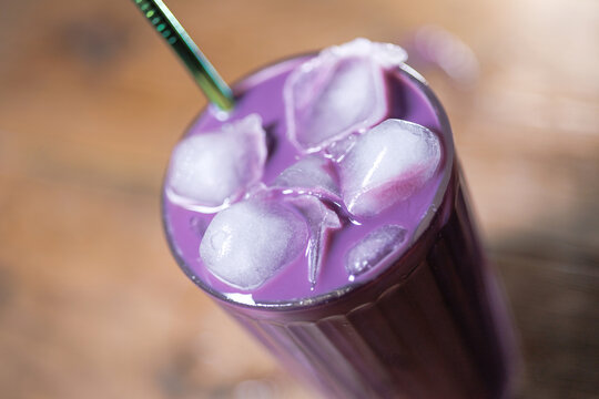 A refreshing ube iced coffee served in a clear glass