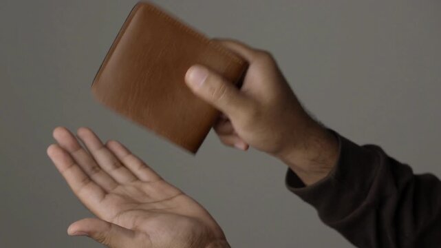 Closeup 4k video of a young businessman shaking her empty wallet without money cash wealth business