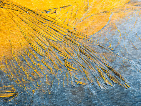 Abstract background of yellow and gray ice formations, creating a unique texture, Alveo Presena,Trentino,Tonale Pass,Italy.