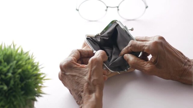 close-up of elderly man hand opening wallet purse retirement ruin bankruptcy old financial problems
