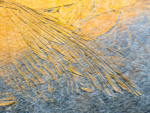 Abstract background of yellow and gray ice patterns, creating a unique texture, Alveo Presena,Trentino,Tonale Pass,Italy.