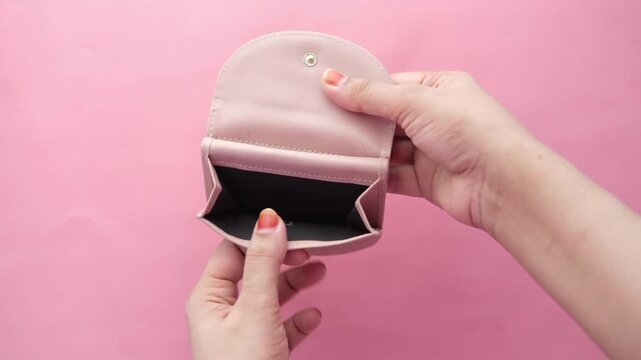 woman shows her empty purses. Bankruptcy empty wallet clutches. The concept of poverty and shopping