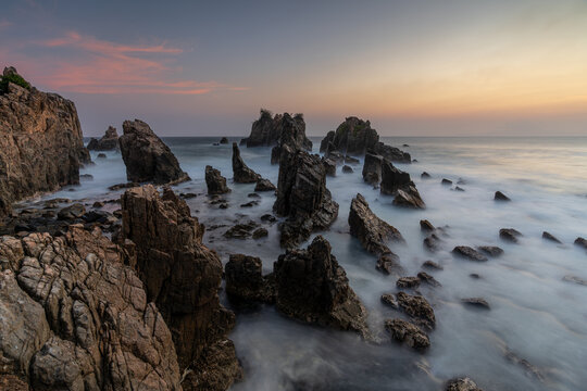 Elevated View of Dramatic Jagged Rock Formations and Silky Water at Gigi Hiu (Shark Teeth) Beach, Lampung