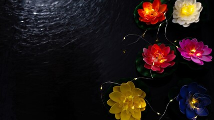 Vesak lantern lotus flowers floating on dark water, Buddha birthday celebration background © Mantas Žiličius