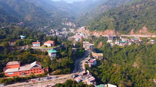 Aerial Landscape of Curving Mountain Road with Moving Traffic and House on Green Hillside, solan himachal pradesh india 