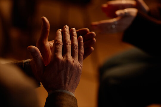 Close up of middle aged adults clapping during standup performance on stage, showing audience engagement and live entertainment. Useful for comedy event promotion, ticketing, nightlife marketing
