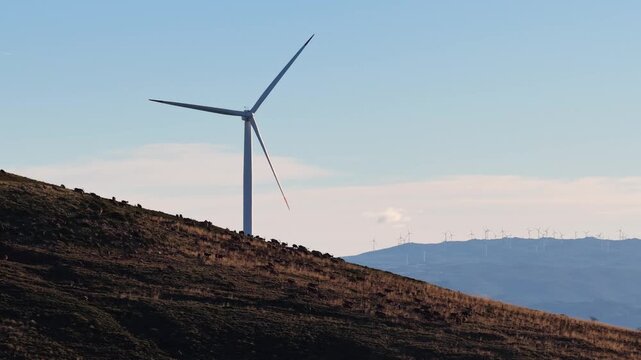 Aerial view of wind turbines on hills, a striking display of renewable energy against the serene landscape, Amarante, Portugal.